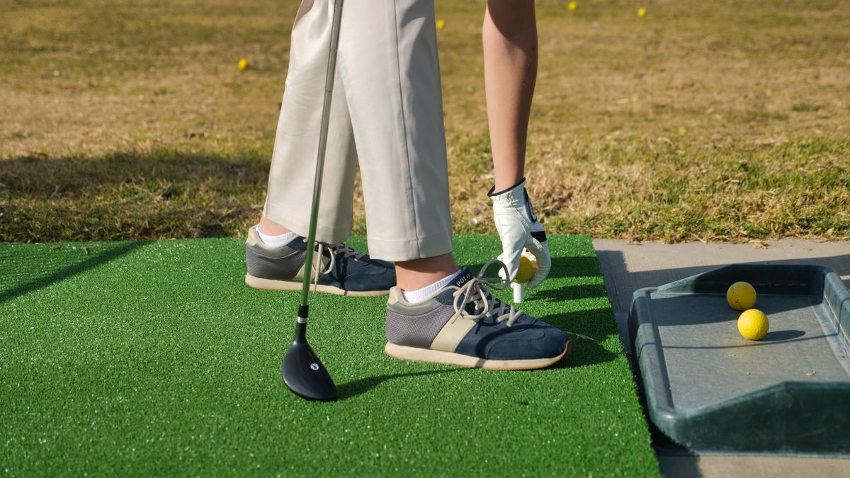 Golfer teeing up a ball at the start of a round